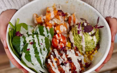 Colourful lunch bowl at North Laine Cafe Brighton with roasted sweet potato, smashed avocado, spinach, tomato and creamy dressing
